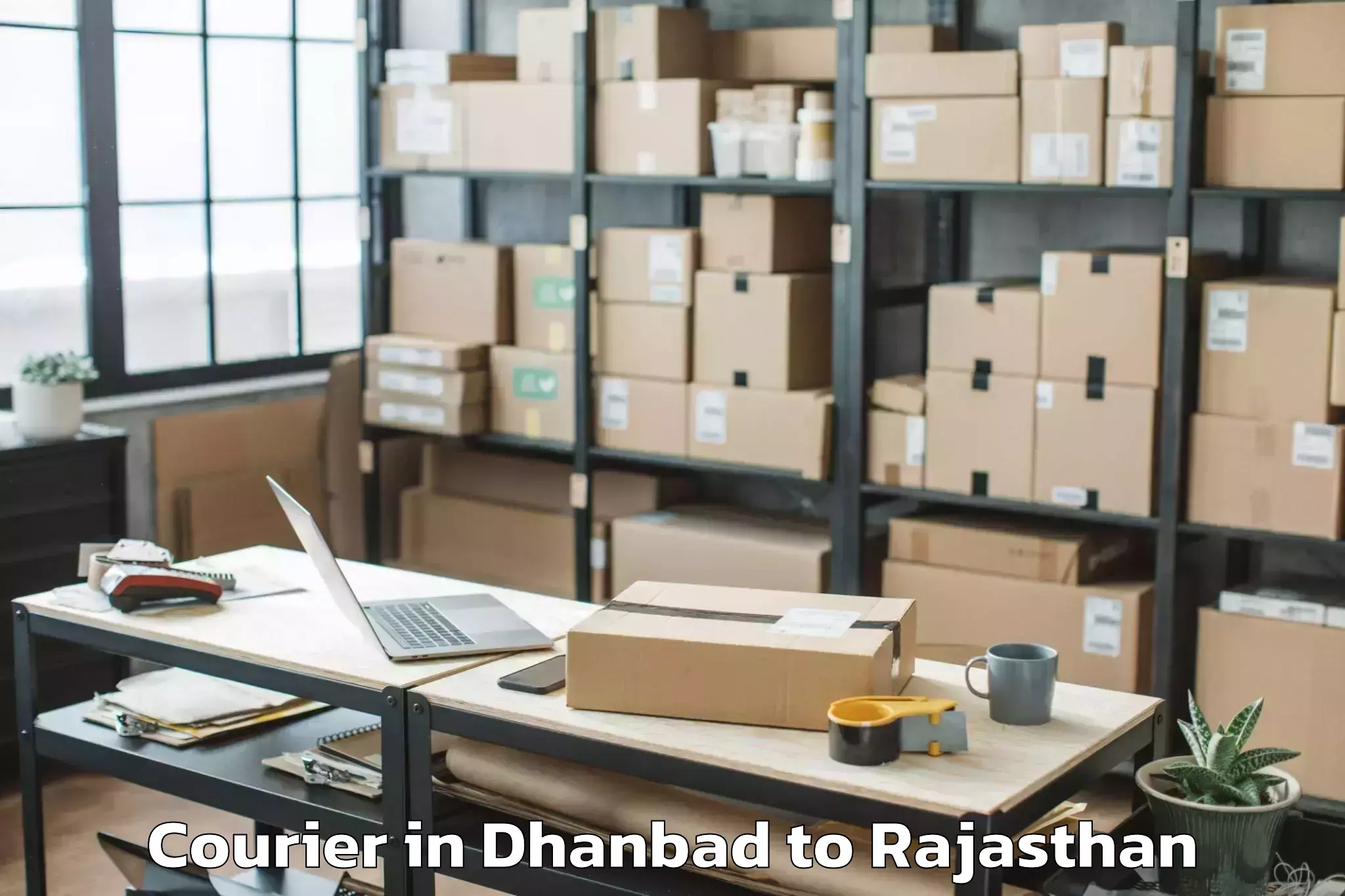 Reliable Dhanbad to Opjs University Churu Courier